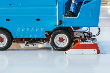 Cropped photo of special machine leveling ice rink in motion, side view/ ice maintenance machine...