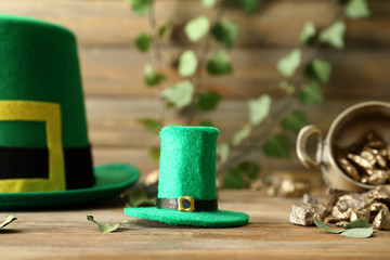 Leprechaun hat with gold nuggets on wooden table. St. Patrick's Day celebration