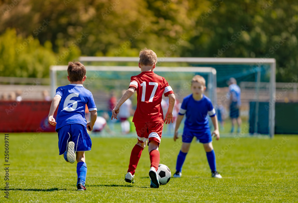 Wall mural boys football soccer players running with ball. soccer school tournament game