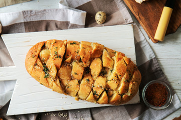 Tasty garlic bread on table