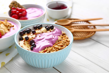 Bowl with tasty acai smoothie on table