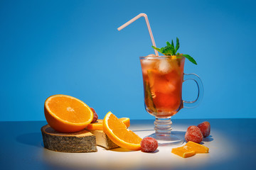 Spring orange cocktail with frozen strawberries.