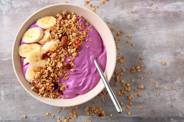 Bowl with tasty acai smoothie on table
