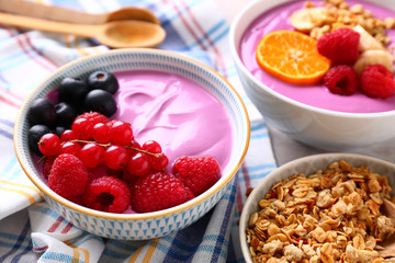 Bowls with tasty acai smoothie on table