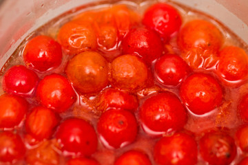 The cranberry is red in water in a glass