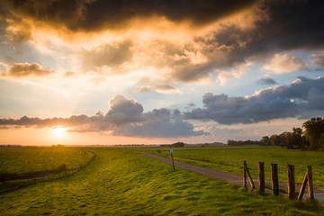 Pastoral landscape by dawn with cloudy sky