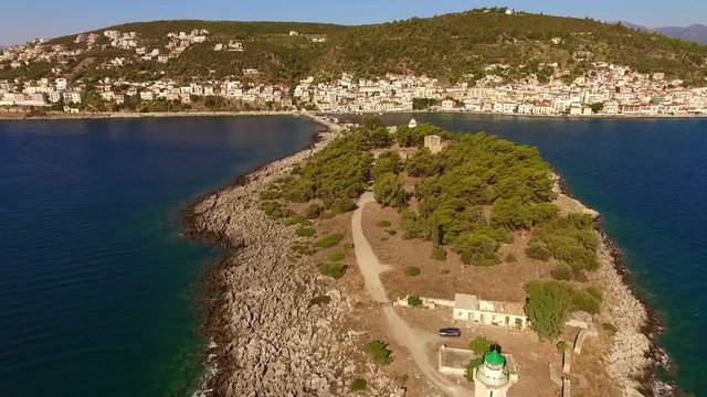 Aerial drone video of famous small islet of Kranai known for old lighthouse and tower of Tzannetakis, Gytheio, Lakonia, Peloponnese, Greece