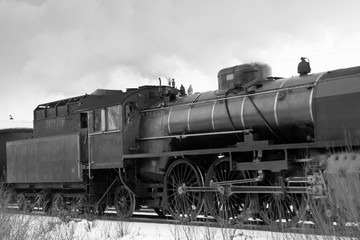Fototapeta na wymiar Old retro steam train at winter morning in Finland. WB photo