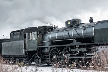 Obraz na płótnie Canvas Old retro steam train at winter morning in Finland