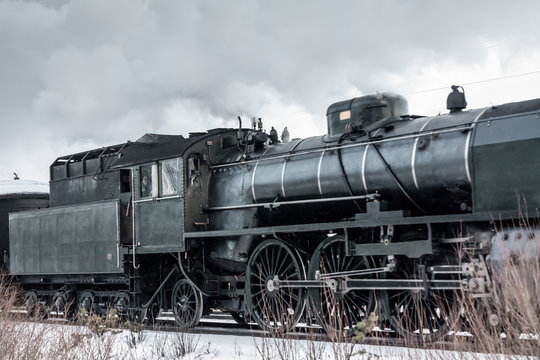 Old retro steam train at winter morning in Finland © Elena Noeva