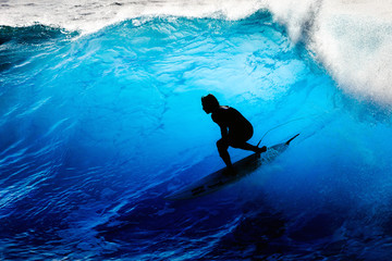 Fototapeta Silhouette surfer riding the big blue surf waves on the island Madeira, Portugal, a popular surfing tourist destination obraz
