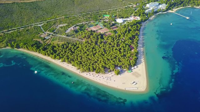 Aerial bird's eye view video taken by drone of exotic seascape and sandy beach with turquoise clear waters and pine trees, Gregolimano, North Evoia island, Greece