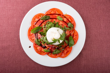 Italian burrata cheese served with sliced tomatoes