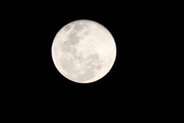 First moon after the full moon with distinct craters visible on the upper edge