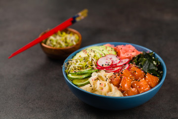 Hawaiian salmon poke bowl with seaweed, avocado, sesame seeds.