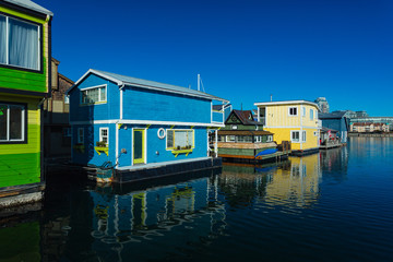 Fototapeta na wymiar Colorful wooden floating houses on sunny summer day with blue sky.