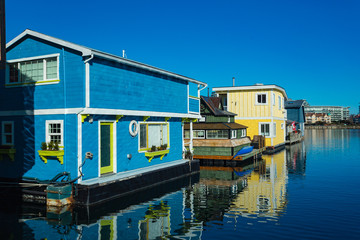 Fototapeta na wymiar Colorful wooden floating houses on sunny summer day with blue sky.