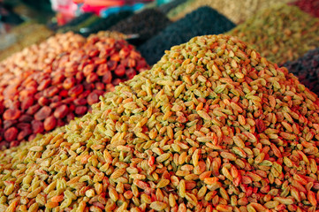 Raisins and other dried fruits piles at marketplace.