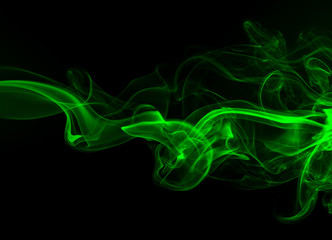 Green smoke abstract on a black background, darkness concept