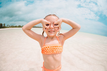 Cute little girl at beach during summer vacation - Powered by Adobe