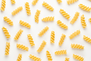 Italian twisted pasta fusilli isolated on white background. Fusilloni, rotini.