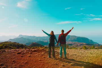 happy couple hiking in mountains, family travel in nature