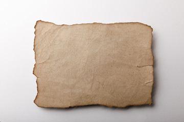 top view of old parchment sheet lying on white background
