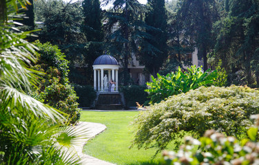Rotunda in antique style in an olive grove near the pond