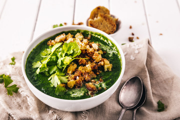 creamy spinach soup with fresh croutons and parsley