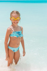 Adorable little girl at beach during summer vacation