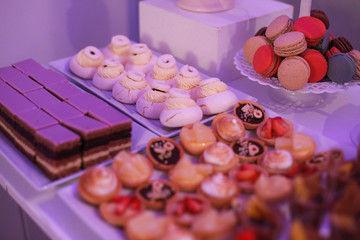 Delicious candy bar with macarons, cupcakes, cake pop and other sweets
