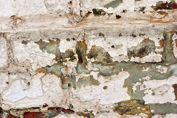 Cracked paint, plaster of soft gray color on brick wall surface close up detail, grunge horizontal shabby background