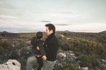 Father playing and having fun with his son on the field. Happy father and child