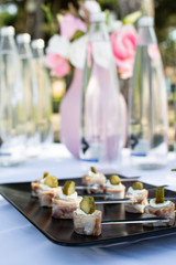  canapes with meat and pickles on toast