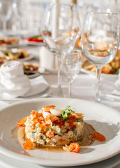 Olivier salad, traditional salad, restaurant dish, salad with shrimp and quail eggs and red caviar, new year's salad,