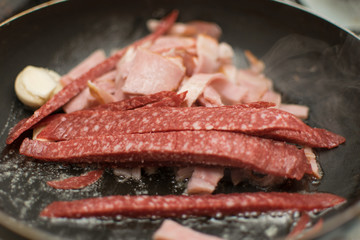 Fry the sliced sausage in the pan.