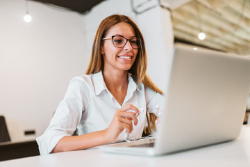 Close-up image of female entrepreneur using laptop.