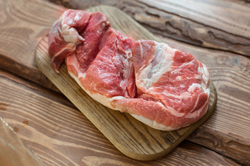 Fresh raw pork on wooden background.