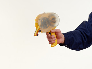 man in overalls holds tool adhesive tape on white background.