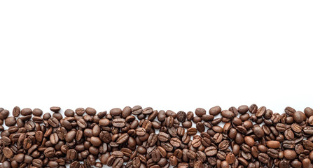 Roasted coffee beans isolated on white background. Close-up.