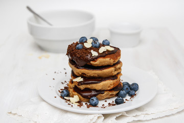 Eggless pancakes for breakfast with blueberries and chocolate sauce