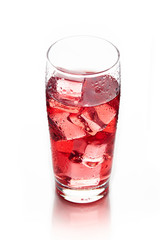 Red ice tea in glass with ice cubes isolated on white background