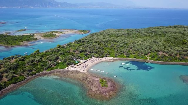 Aerial view video from famous organised beach in small island of Monolia part of archipelago paradise exotic islands of Lihadonisia with clear turquoise sea beaches, North Evoia island, Greece