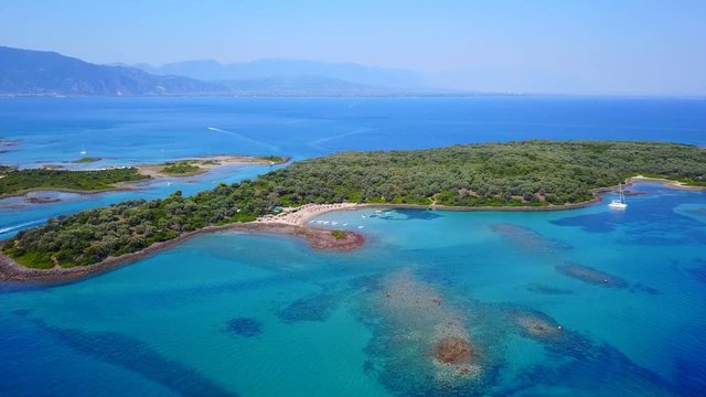 Aerial view video from famous organised beach in small island of Monolia part of archipelago paradise exotic islands of Lihadonisia with clear turquoise sea beaches, North Evoia island, Greece