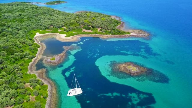 Aerial view video from famous organised beach in small island of Monolia part of archipelago paradise exotic islands of Lihadonisia with clear turquoise sea beaches, North Evoia island, Greece