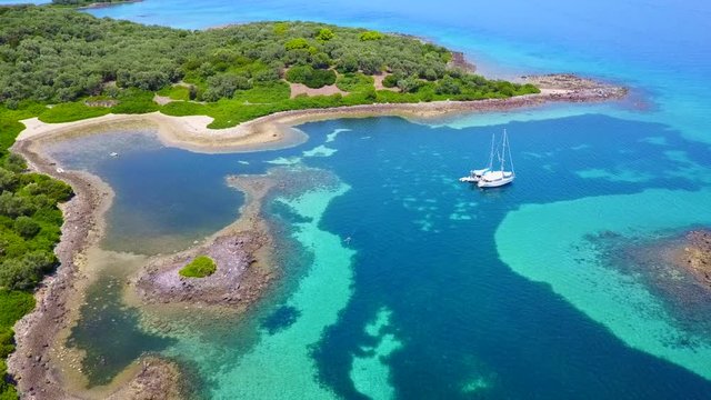 Aerial view video from famous organised beach in small island of Monolia part of archipelago paradise exotic islands of Lihadonisia with clear turquoise sea beaches, North Evoia island, Greece