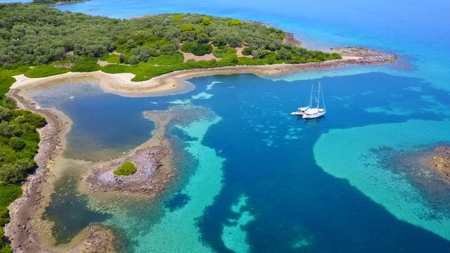 Aerial view video from famous organised beach in small island of Monolia part of archipelago paradise exotic islands of Lihadonisia with clear turquoise sea beaches, North Evoia island, Greece