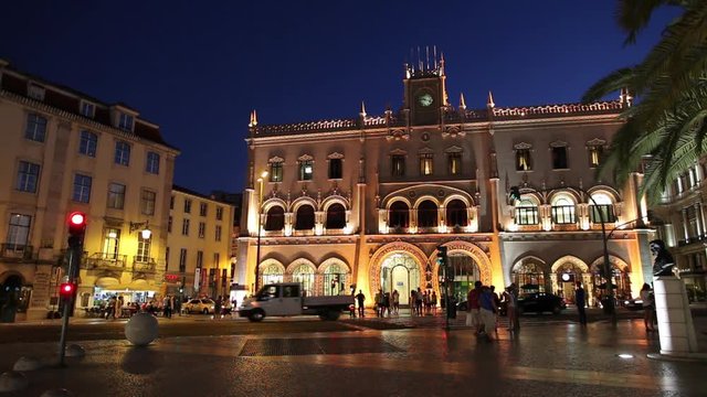 WS Traffic in front of Rossio railway station illuminated at night / Lisbon, Portugal
