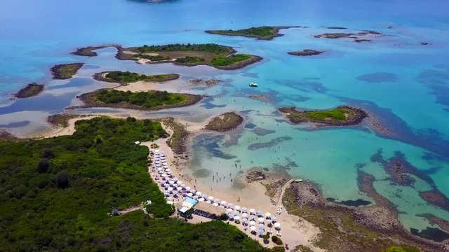 Aerial view video from famous organised beach in small island of Monolia part of archipelago paradise exotic islands of Lihadonisia with clear turquoise sea beaches, North Evoia island, Greece
