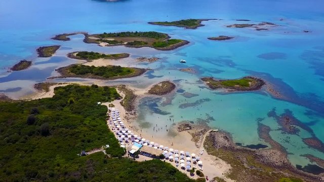 Aerial view video from famous organised beach in small island of Monolia part of archipelago paradise exotic islands of Lihadonisia with clear turquoise sea beaches, North Evoia island, Greece
